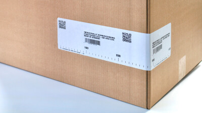 Cardboard box with corner-wrap label