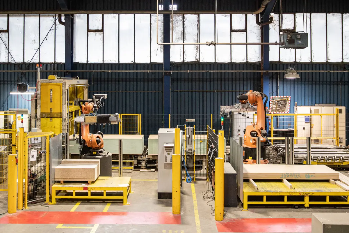 Labeling system and robot applying labels in a production hall