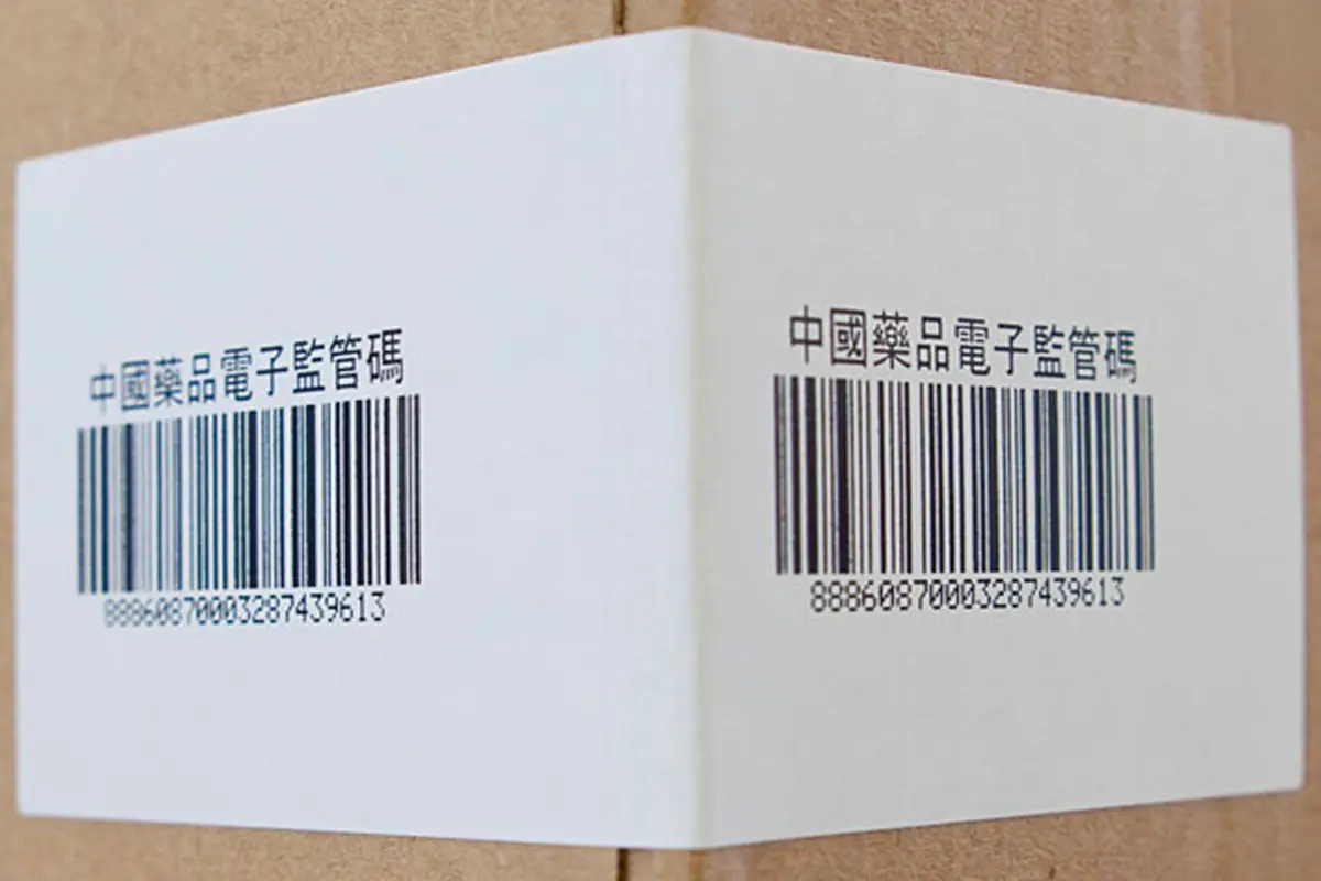 Barcode label applied on cardboard with Asian characters